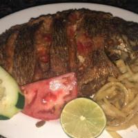 Poisson Frit · Grilled fish marinated in lemon juice and garlic served with seasoned onions.