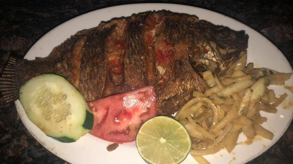 Poisson Frit · Grilled fish marinated in lemon juice and garlic served with seasoned onions.