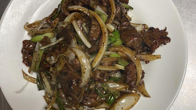 Mongolian Beef · Spicy. Sliced beef stir fried with onion and cooked with chefs special secret black pepper sauce and served on a bed of crispy noodles.