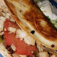 Frida’S Quesadilla · A flour tortilla stuffed with cheese, steak, chicken, shrimp, onions, tomatoes, and bell pep...