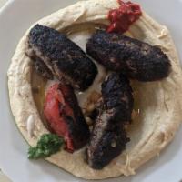 Kebab Hummus · Grilled beef kebab, tahini, and parsley on hummus. Served with your choice of white or wheat...