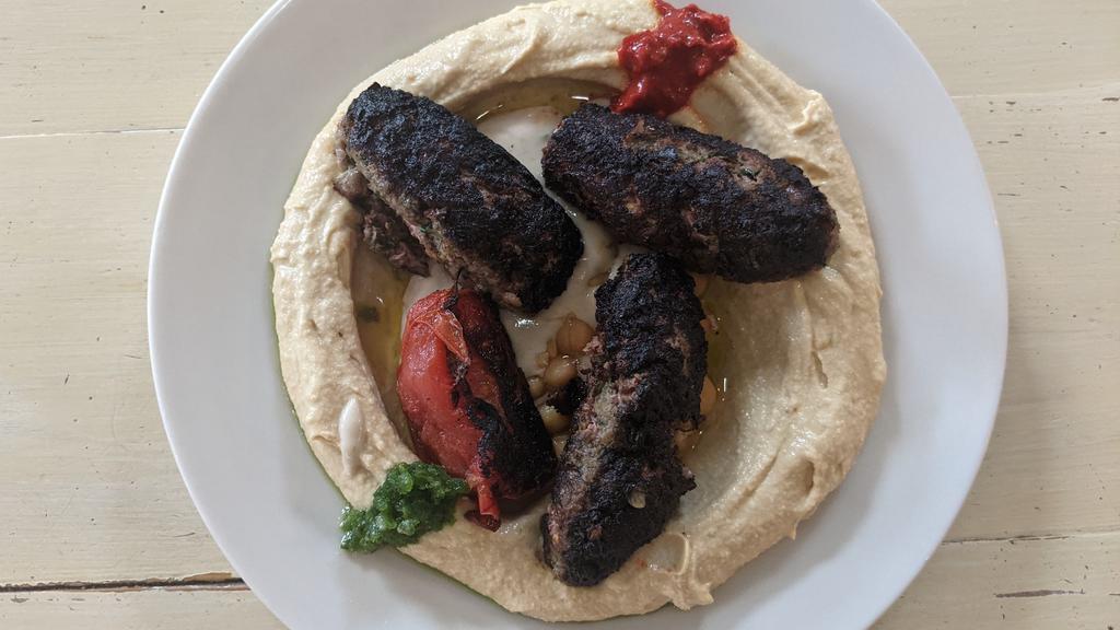 Kebab Hummus · Grilled beef kebab, tahini, and parsley on hummus. Served with your choice of white or wheat pita.