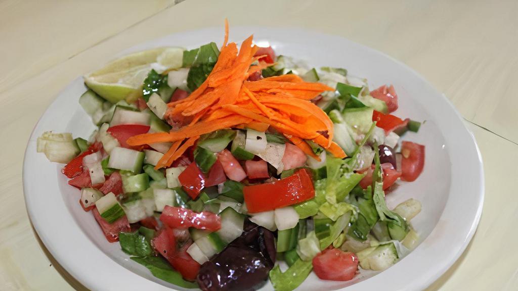 Israeli Salad · Diced cucumber, tomato, green onion, lemon juice, extra virgin olive oil, and parsley.