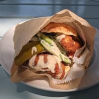 Shnitzel Pita · Thin cut, breaded and deep-fried chicken breast served in a pita and dressed with hummus, ta...