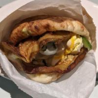 Sabich Pita · Thin cut slices of deep-fried eggplant served in a pita and dressed with hard-boiled egg, Is...
