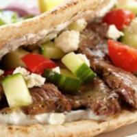 Pita Lamb · 7 hour stewed lamb shank served in a pita and dressed with Israeli salad on your choice of w...