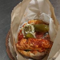 Pita Shakshuka · Pita sandwich with eggs poached in tomato sauce, falafel, feta, and Israeli salad on your ch...