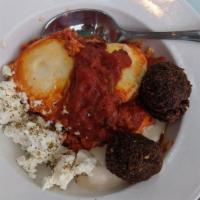 Shaksuka Platter · Three eggs poached in tomato and red pepper sauce with tahini, falafel, feta, Israeli salad,...