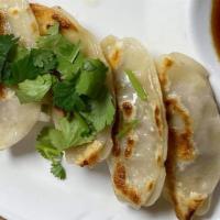 Gyoza · Pan seared pork dumplings served with sweet ginger soy sauce.