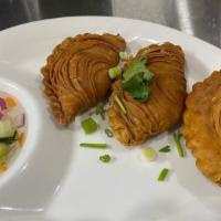 Curry Puff · Deep fried puff pastry stuffed with potatoes, onions, carrots and chicken seasoned curry pow...