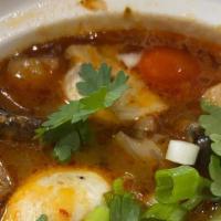 Tom Yum · Spicy lemongrass soup with mushrooms, cherry tomatoes, cilantro and scallions.