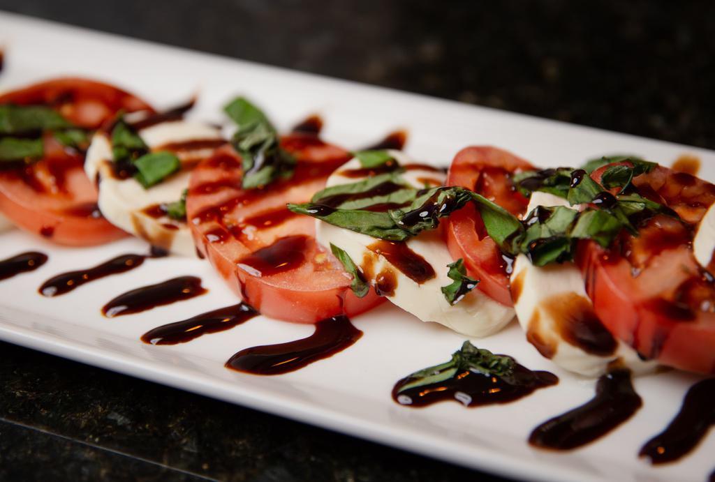 Caprese · Fresh mozzarella, roma tomatoes and fresh basil with extra virgin olive oil and balsamic reduction.