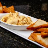 Central Hummus · Chickpea, lemon, confit garlic, served with toasted pita points.