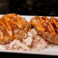 Jumbo Lump Crab Cakes · Pan seared crab cakes served with a cajun rémoulade and coleslaw.