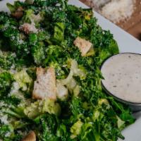 Romaine Caesar Salad · Shaved romaine, parmesan cheese and garlic croutons dressed with a Caesar dressing.