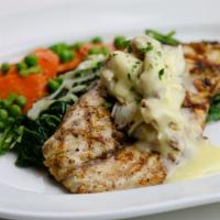 Wood Grilled Redfish · Cajun seasoned with lemon butter sauce and Louisiana blue crabmeat paired with seasonal vege...