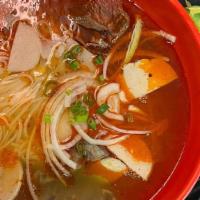 Bun Bo Hue · Traditional Vietnamese noodle soup, spicy lemongrass ginger broth with beef shank and steame...