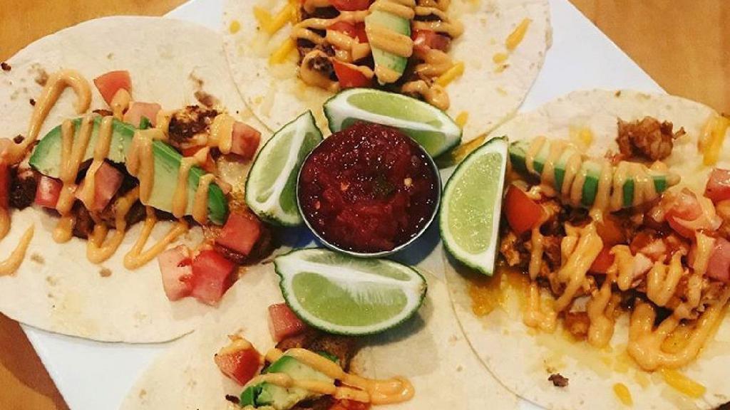 Baja Avocado Tacos · 2 tacos served with tomato, cilantro, and avocado served with a side of baja sauce and chips & salsa. Beef and chicken served with cheddar jack cheese. Shrimp and fish served with a lime wedge.