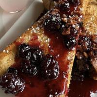 Ricotta Stuffed French Toast · House made sweet ricotta, berry compote, and crumbled bacon.