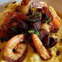 Shrimp & Grits · Cajun shrimp, Portuguese sausage, and chives over cheddar grits.