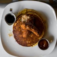 Fried Chicken & Cornmeal Pancakes · Buttermilk fried chicken cornmeal pancakes, topped with maple butter and a side of peach hab...