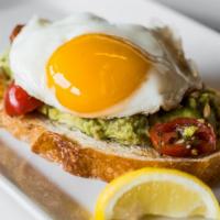 Avocado Toast · Garlic heirloom tomatoes, sunflower seeds, and an over easy egg on rustic sourdough.