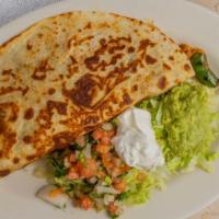 Fajita Quesadilla · A flour tortilla grilled and stuffed with grilled ribeye or chicken and topped with shredded...