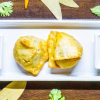 Samosa (2 Pieces) · Crispy fried dumplings filled with spiced potatoes and peas served with chutney.
