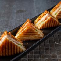 Chicken Masala Grill Sandwich · Double layered grilled cheese sandwich with marinated tandoori chicken and veggies.