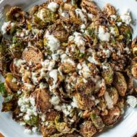Blue Devil Brussels · Fried brussel sprouts with garlic aioli, cave aged blue cheese, thyme and a balsamic reducti...