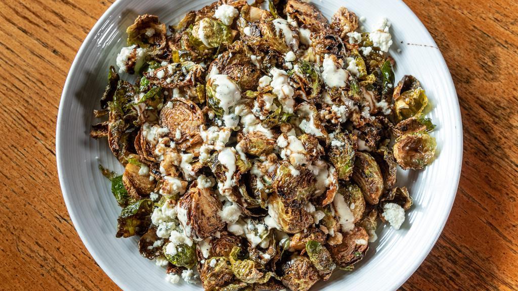 Blue Devil Brussels · Fried brussel sprouts with garlic aioli, cave aged blue cheese, thyme and a balsamic reduction.