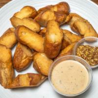 O’Connell Street Pretzel Bites · Fried soft pretzels with beer queso and whole grain mustard.
