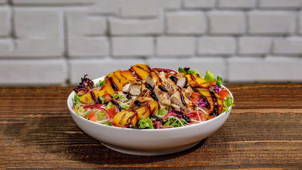 Chargrilled Peach Salad · Chargrilled Chicken | Grilled Peaches | Balsamic Glaze | Pickled Red Onions | Tomatoes | Parmesan Cheese | Hand-cut Garden Greens | Citrus Dijon Dressing