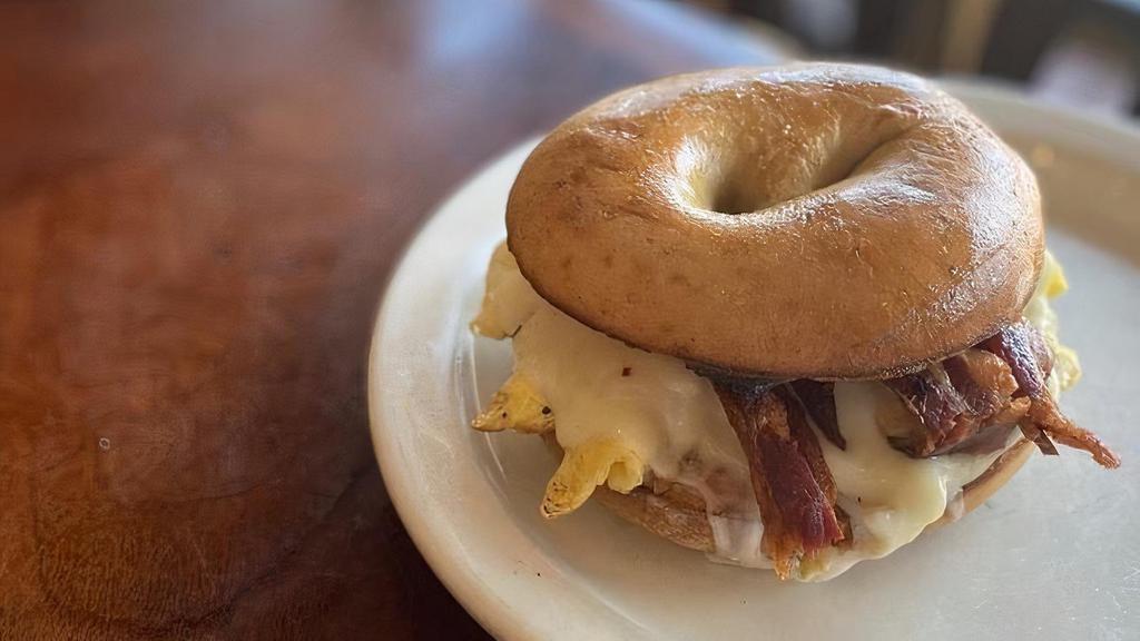 Bec Bagel · Local Dave's Bagels plain bagel with 2 scrambled eggs, provolone cheese and Marmilu farms bacon.