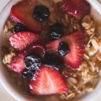 Granola & Yogurt · Housemade unsweetened yogurt &  granola topped with seasonal berries.