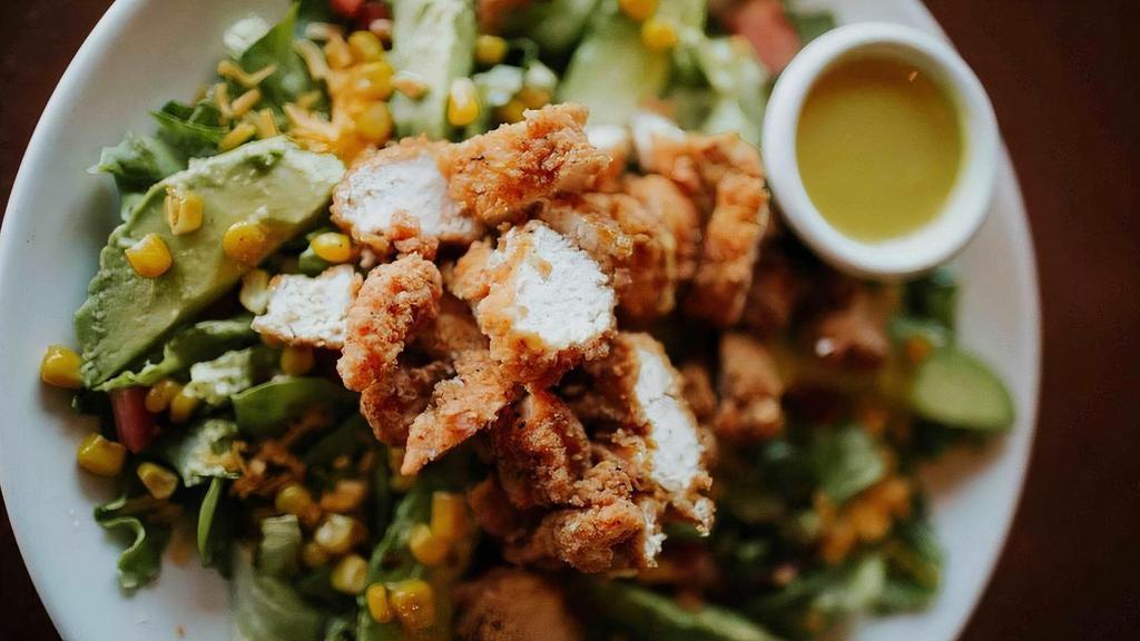 Commander Salad · An old favorite from Zinnie’s East - fried chicken, cherry tomatoes, sliced avocado, grilled corn, & yellow cheddar served on a bed of fresh mixed greens with the dressing of your choice.