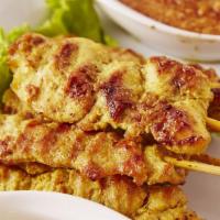 Chicken Satay · Slices of chicken breast marinated in curry sauce, coconut milk and served with our flavorfu...