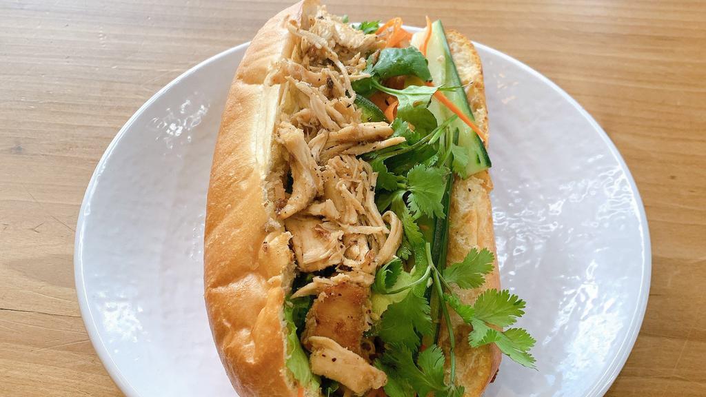 Vietnamese Pulled Chicken Banh Mi · All white meat pulled chicken with Vietnamese mayo, cilantro, cucumber, jalapeno, pickled carrots & daikon and lettuce.