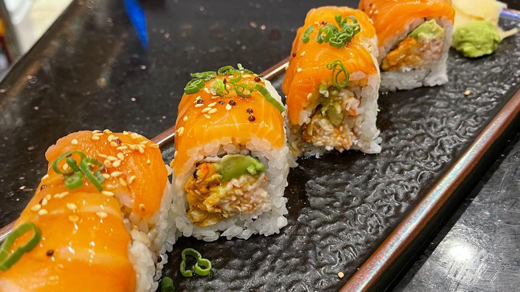 Geisha Roll · Roll contains raw fish. Inside: spicy crawfish, snow crab, avocado. Top: salmon, green onion, sesame seed, yuzu sauce.