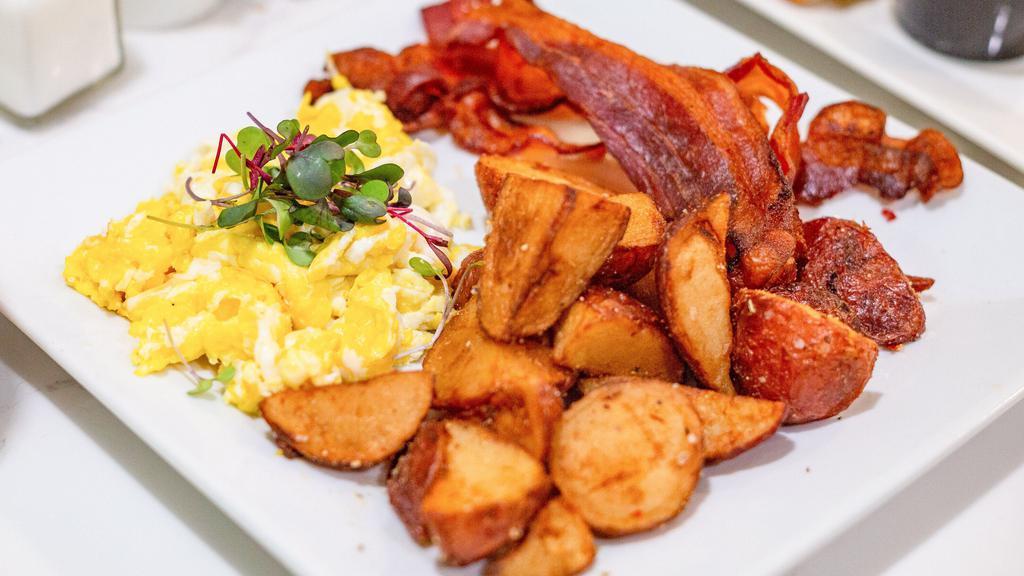 Eggs Your Queens Way · Two eggs, rosemary potatoes, bacon, sausage or vegan sausage, and choice of toast.