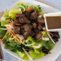 Steak Salad · Sliced onions, tomatoes, cucumbers and marinated cubed flank steak on a bed of romaine lettu...