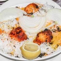 Chicken Biryani · Aromatic long grain basmati rice, saffron, caramelized onion, and aromatic spices.