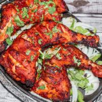 Angarey Tandoori Chicken · Marinated chicken, spices, and herbs.