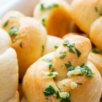Signature Garlic Knots · Freshly baked with a savory blend of fresh garlic, virgin olive oil, oregano, and parsley fi...