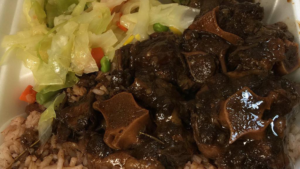 Oxtail · Marinated and cooked to perfection with garlic, thyme, scotch bonnet pepper, onion and mixed jamaican spices.  Small consist of 3-4, md 4-5 and large 5-6 depending on the size of oxtails.