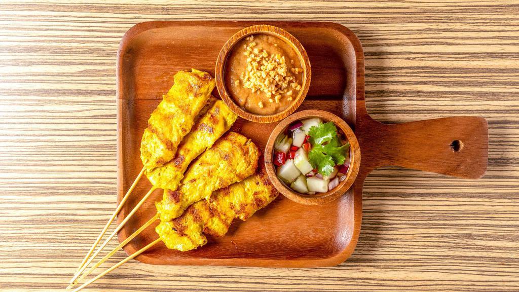 Chicken Satay (4) · Chicken tenders marinated in coconut milk, thai spices, char-grilled, served with peanut sauce and cucumber salad.