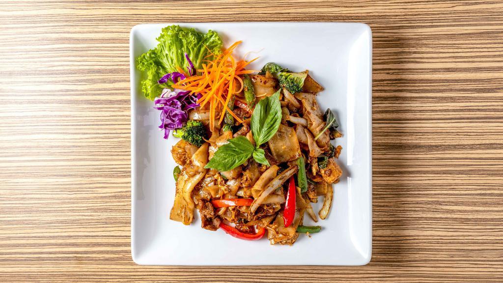 Crispy Drunken Noodles · Stir-fried crispy flat noodles with eggs, baby corn, basil leaves, bell peppers and onions in a sweet chili basil sauce.