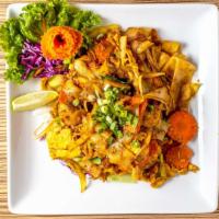 Twisted Yellow Curry Noodles · Stir-fried flat noodles with eggs, onions, carrots and scallions in yellow curry powder, ser...