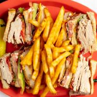 The Club · A triple-decker sandwich made with a half-pound of sliced turkey breast, cheese, bacon, lett...