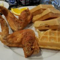 Chicken & Waffles · Two big fried chicken wings and our original recipe Belgian waffle. Served with whipped butt...